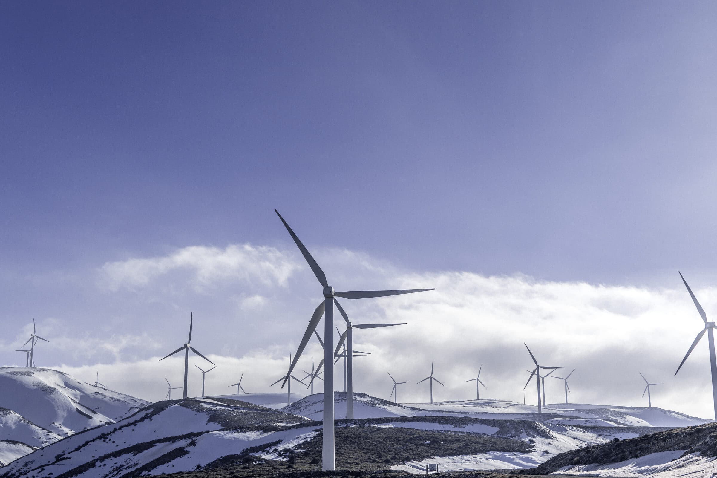Wind turbines on a snow-covered ridge